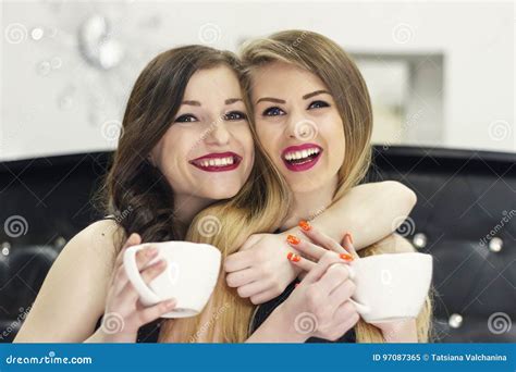 Two Girl Friends Drinking Tea Coffee And Laughing Stock Image Image