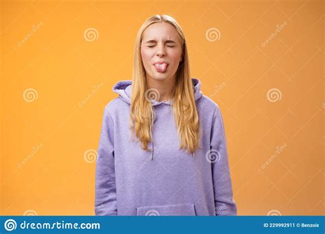 Playful Amused Charismatic Young Funny Blond Girl Having Fun Close Eyes Showing Tongue