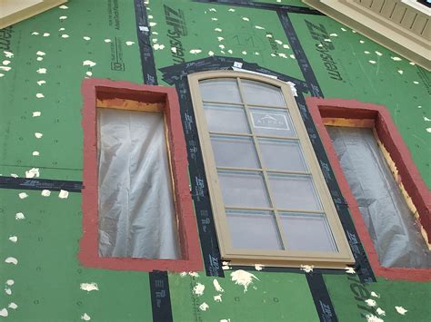 The rough openings for the windows are flashed with a paint-on flashing ...