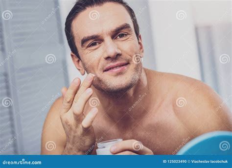 Beaming Dark Eyed Man Creaming His Handsome Face Stock Photo Image Of