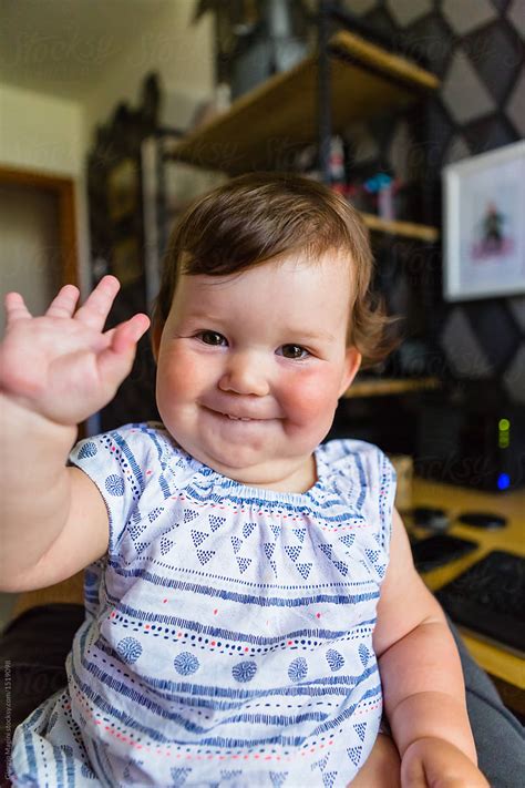 Chubby Infant Baby At Home Waving At Camera By Stocksy Contributor