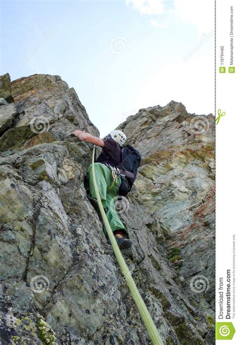 Male Rock Climber On A Steep Climbing Route In The Alps Stock Photo