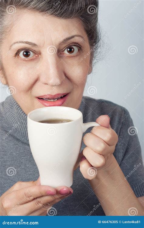 an elder smiling woman holding cup of tea stock image image of beauty closeup 66476305