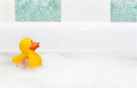 Premium Photo Rubber Duck In Foam Bath