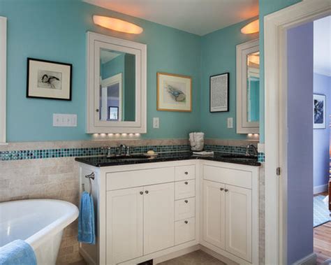 Corner of modern bathroom with white and brown tiled walls, tiled floor, comfortable double sink standing on gray countertop with round mirrors and white bathtub. Corner Double Vanity | Houzz