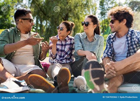 Friends Hanging Out And Talking Outdoors In Summer Stock Photo Image