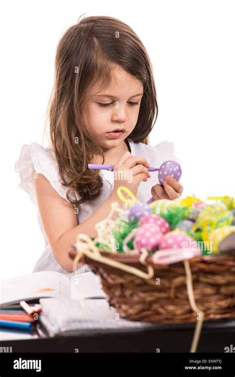 Little Girl Painting Easter Egg Against White Background Stock Photo