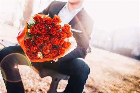 Man Holding A Bouquet Of Red Roses Free Stock Photo Picjumbo