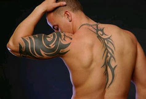 Black tribal tattoo on right shoulder and front shoulder. 61 Tribal Shoulder Tattoos