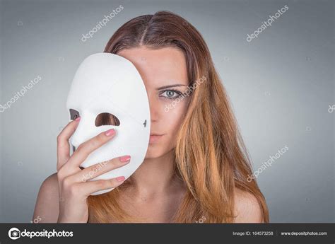 Young Emotional Woman Holding Mask In A Hands Pose In