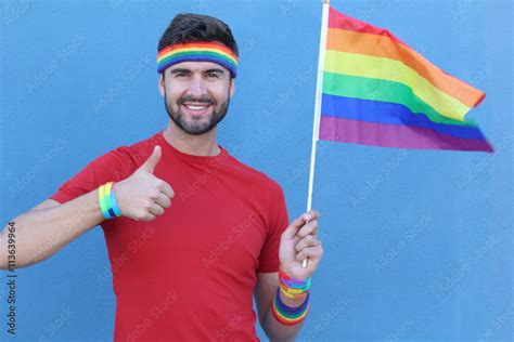 Handsome Gay Man Showing Hand Like Thumb Up Holding Rainbow Gay Flag