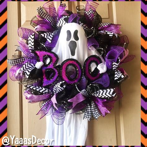A Wreath Decorated With Purple And Black Mesh Ribbons Ghost Head And