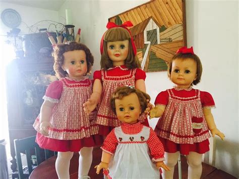 three dolls are standing next to each other on a table