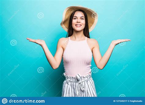 Shrugging Woman In Doubt Doing Shrug Showing Open Palms Gesturing Look To Side On Blue