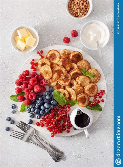 American Mini Pancake Board With Berries And Maple Syrup Stock Photo
