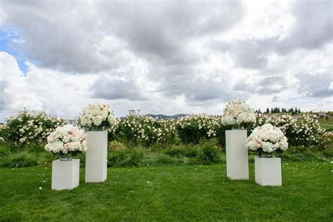 Factors that affect wedding flowers cost. Bodacious altar arrangements sitting upon elegant ivory ...