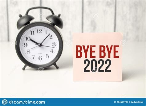 The Word Bye Bye 2022 Written On Pink Sticker And Alarm Clock Stock