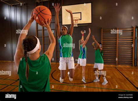 Diverse Female Basketball Team Practicing Shooting With Ball Stock
