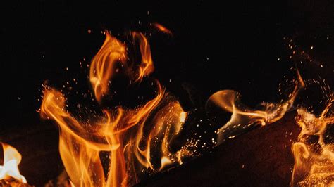 Download Wallpaper 1366x768 Fire Flame Bonfire Sparks Firewood