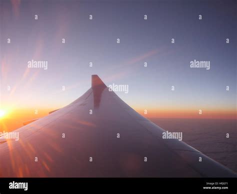 Airplane Wing At Sunset Stock Photo Alamy