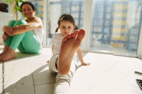 Focus On Foot Of A Little Girl Exercising With Her Mom At Home Stock