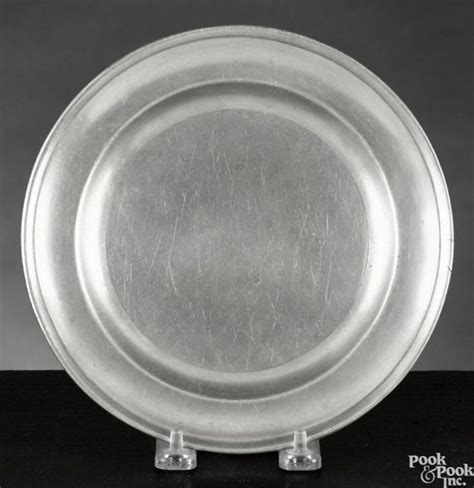 A Silver Plate Sitting On Top Of A Black Table