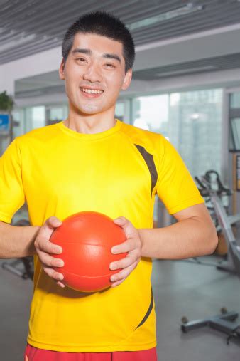 Man Holding Ball In His Hands At The Gym Stock Photo Download Image