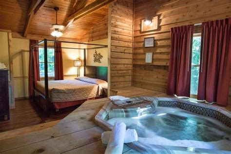 A Log Cabin With A Hot Tub In The Middle