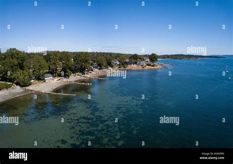 Aerial Panoramic View Of Luxury Homes In Front Of Beautiful Sandy Beach