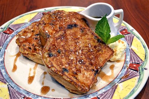 This is a peice of toast dipped in eggs!!! CINNAMON RAISIN CHALLAH FRENCH TOAST - Dipped in Egg Mix, drizzled with Cinnamon Sauce, dusted ...