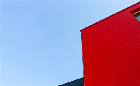 Red And White Concrete Building Under Blue Sky During Daytime Photo