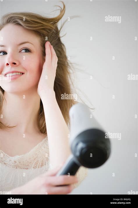 Woman Blow Drying Hair Stock Photo Alamy