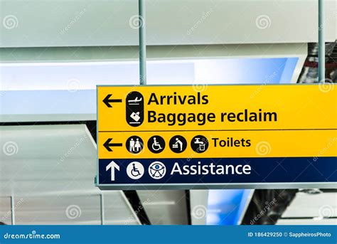 Yellow Directional Sign At The Airport Stock Photo Image Of Signboard