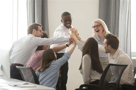 Premium Photo Excited Multiethnic Colleagues Give High Five Achieving