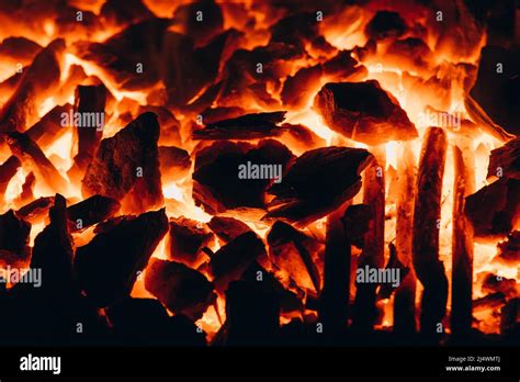 Abstract Background Of Glowing Coals In Fireplace With Fire Flames