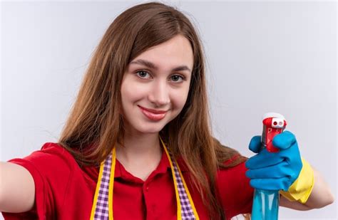 Free Photo Young Beautiful Girl In Apron And Rubber Gloves Holding Cleaning Spray Aiming To