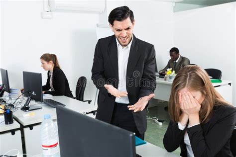 Unhappy Woman Manager Working At Laptop And Angry Man Boss Pointinting