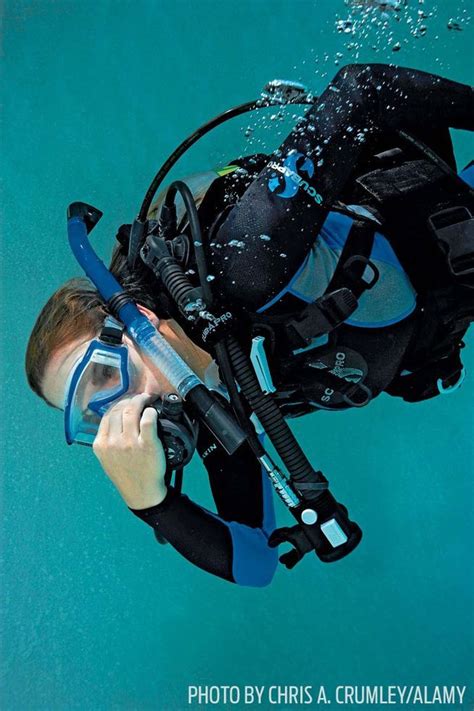 A Man Wearing A Scuba Suit And Snorkels In The Water