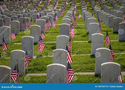 Stone Military Grave Markers Decorated With American Flags For Memorial
