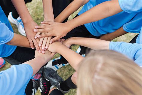 Team Of Competitors In Circle With Hands In Huddle Stock Photos