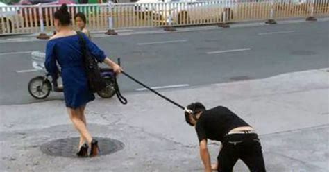 Woman In High Heels Drags Man Around Busy Streets On A Dog Lead In