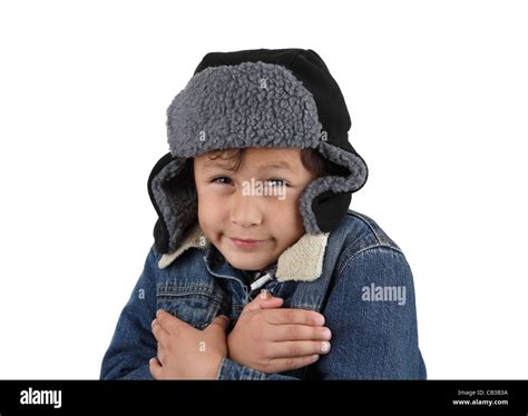 Boy Freezing In The Winter Cold Wearing Woolen Hat And Jacket On White