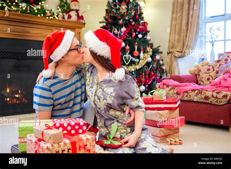 Christmas Morning Kisses Stock Photo Alamy