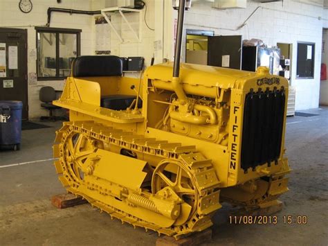 A Large Yellow Bulldozer Sitting Inside Of A Building