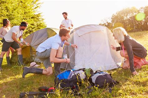 Group Of Young Friends Pitching Tents On Camping Holiday Stock Photo