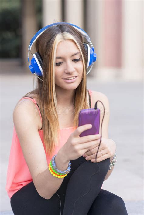 Smiling Beautiful Woman Listening To Music With Headphones And P Stock