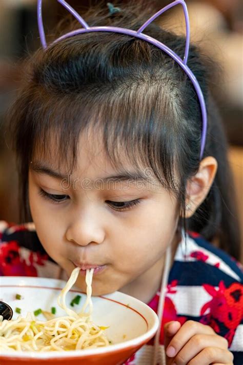 Female Asian Child While Eating Noodles Child Eating Ramen Noodles