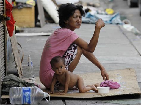 Homeless Mother With One Of Her Children In Manila Philippines This