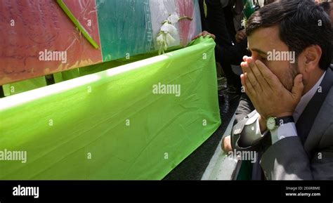 Irans President Mahmoud Ahmadinejad Cries As He Stands Near The Coffins Of Recently Recovered