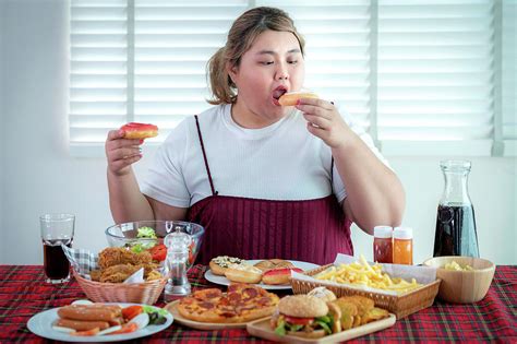 Asian Fat Girl Hungry And Eat A Junk Food On The Table Photograph By Anek Suwannaphoom Fine
